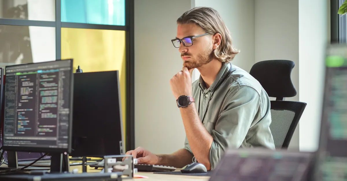 A business owner reviewing cybersecurity compliance requirements on a laptop.